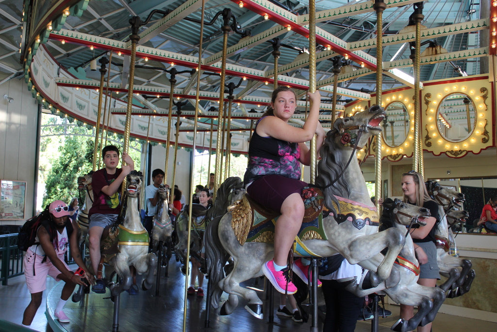 Students and staff on a carousel.