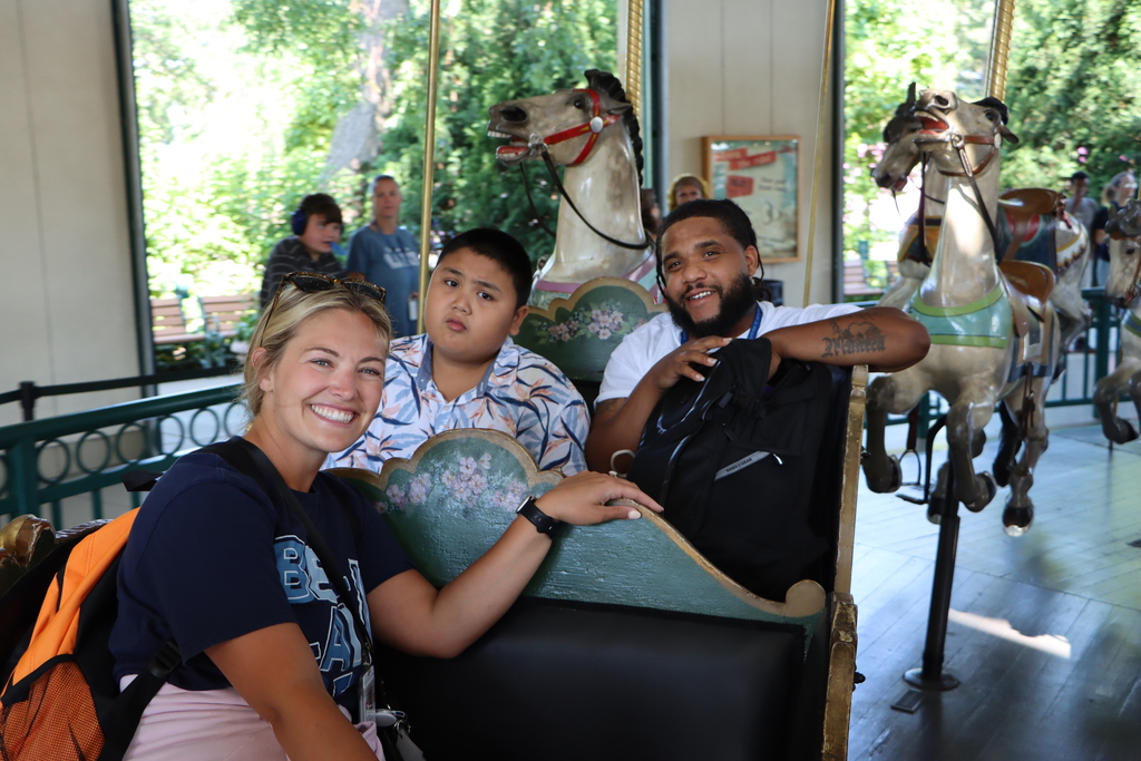 Students and staff on a carousel.