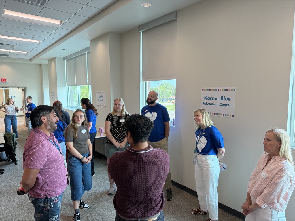 New staff gathered in a circle and talking with each other. 
