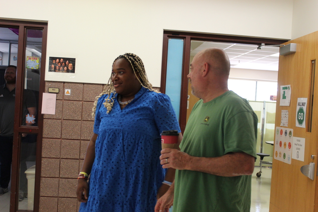 Student and staff talking to each other. 