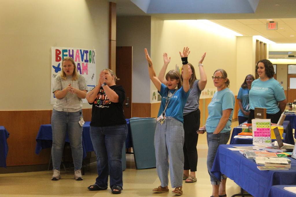 Staff cheering for students during open house. 