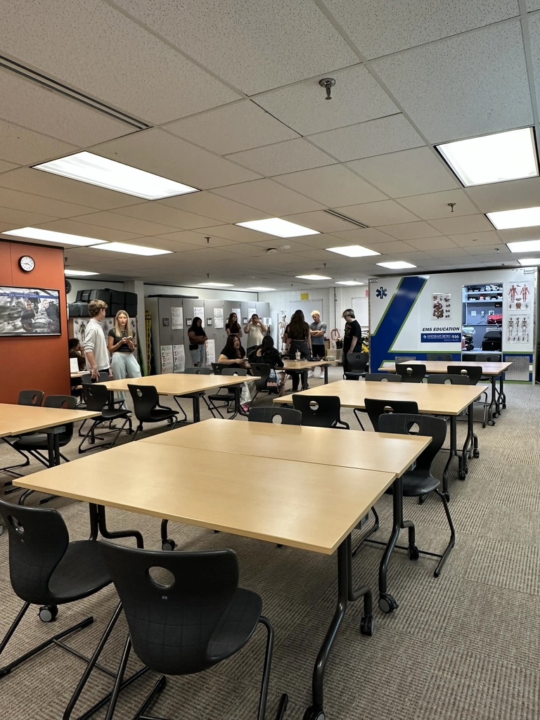 A far shot of students, families, and staff in a classroom during open house. 