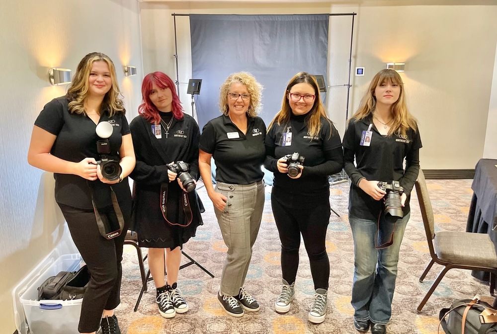 Jennifer Johnson, third from left, and her students have been doing projects in the community, including event photography and headshots at the Miami Area Chamber Women in Business event in 2025.