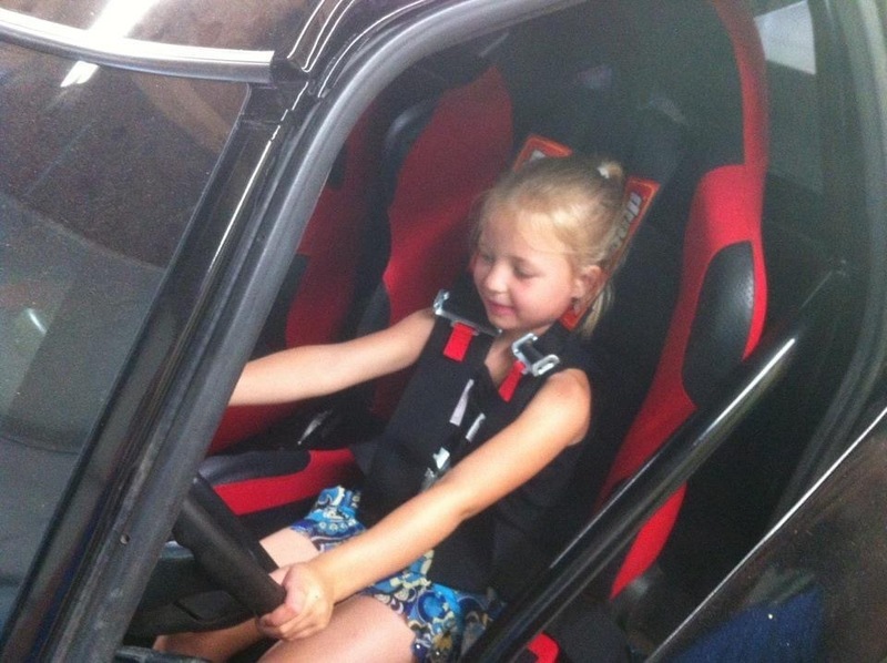 Jazmine Cookson is shown sitting in the front seat of a racing truck as a child. COURTESY