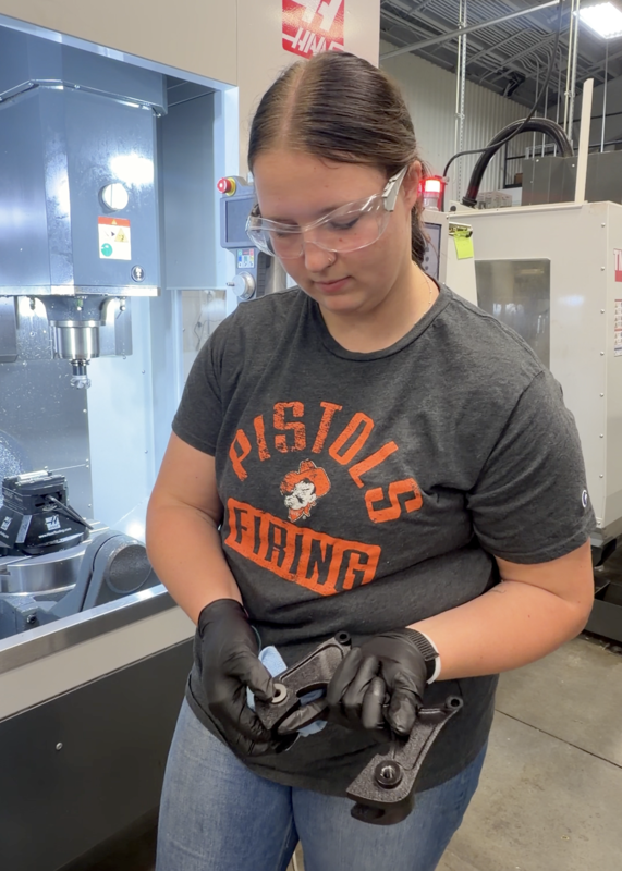 CNC Machining student Jazmine Cookson works on a caliper bracket in the shop. PHOTO BRITTNEY ROGERS
