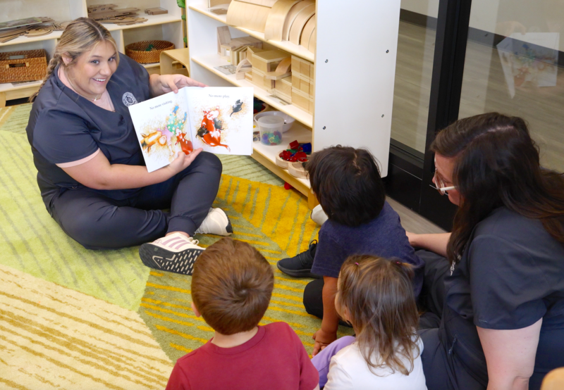 Jessie Chancellor, left, reads a book to the children in her classroom.