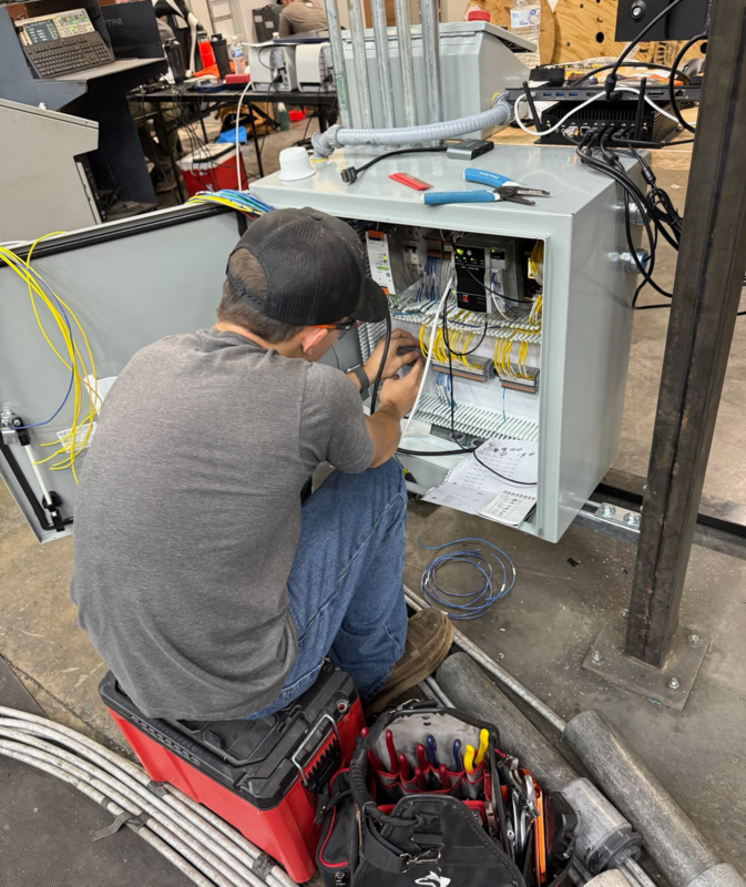 Derek Bailey is seen working on an electrical panel.