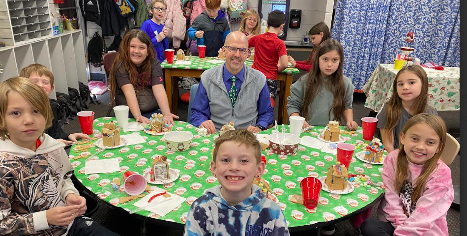 dr streeter with 3rd graders making gingerbread houses