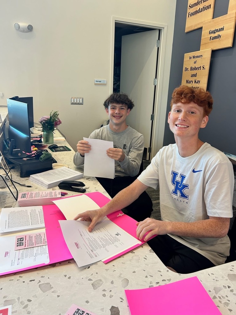 Juniors Tegan Mitchell and Conner Hill prepped packets for attendees