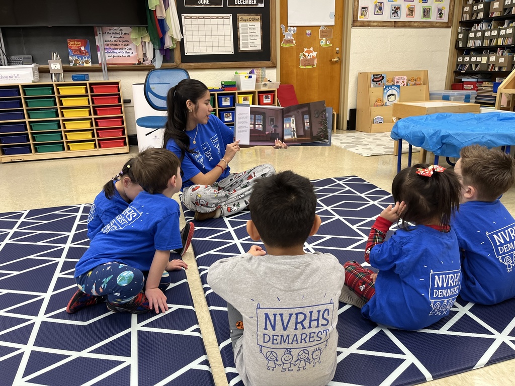 teen reading book to tots