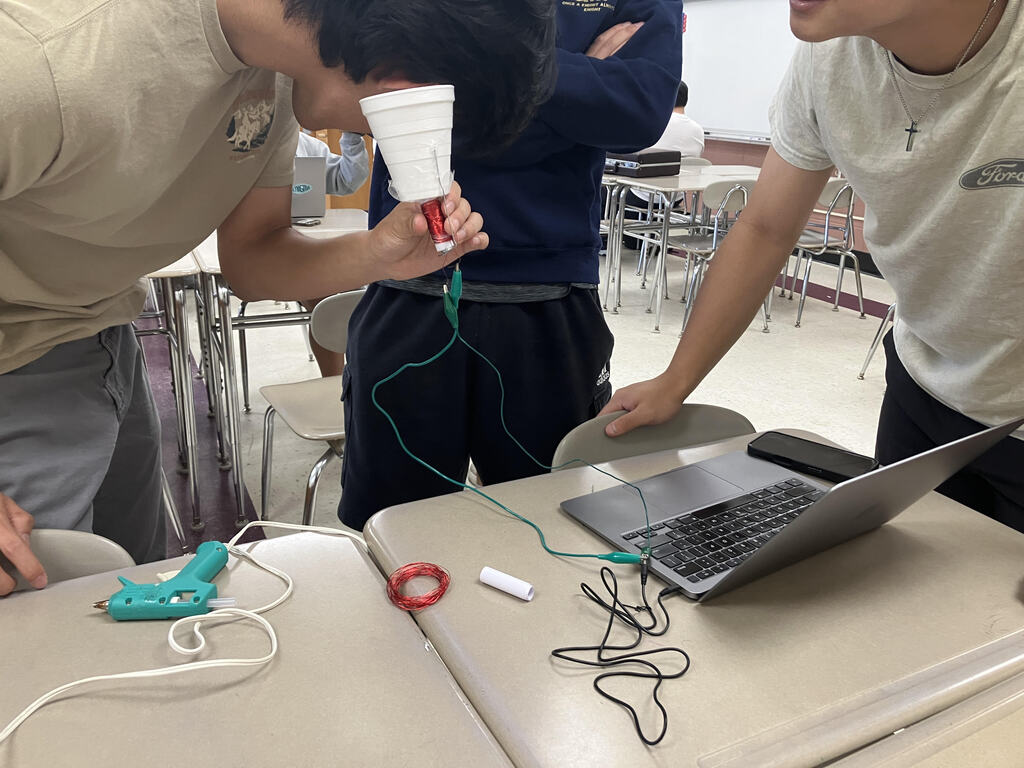 Student with speaker he built.