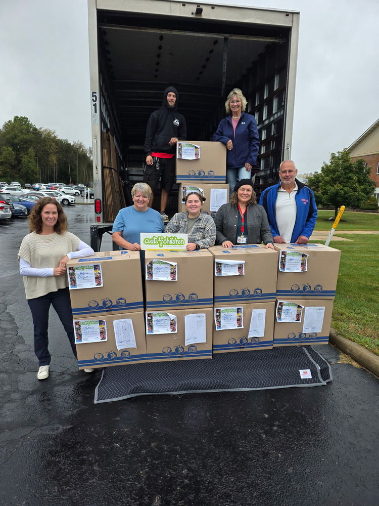 photo of coat4children donating boxes of new winter coats to school