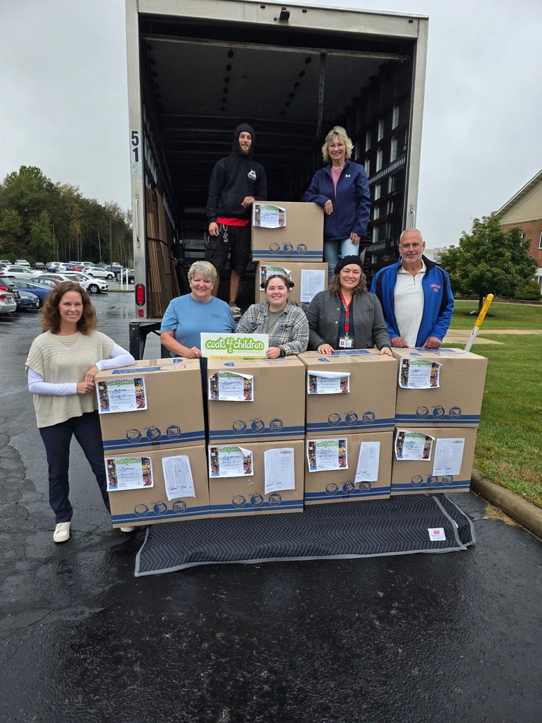 photo of coat4children donating boxes of new winter coats to school