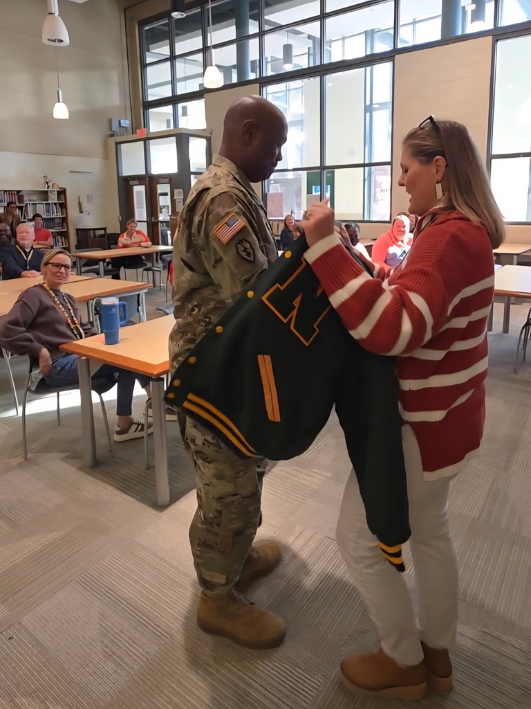 Sgt Lemon receiving lettermans jacket.