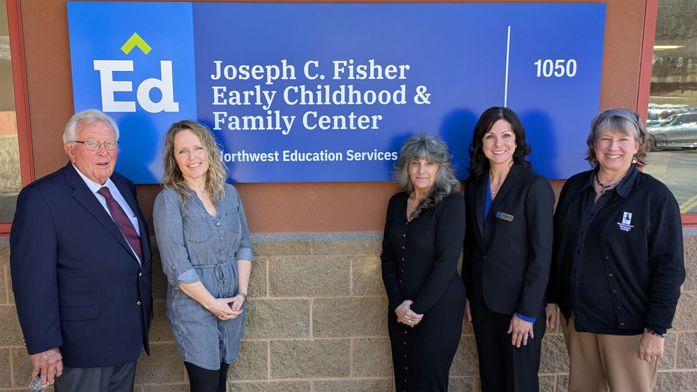 From left, Joe Fisher, Rachael Birgy, Liz Petrella, Tara Mager and Lisa Thomas stand in front of a sign for the Joseph C. Fisher Early Childhood & Family Center at Northwest Education Services. 