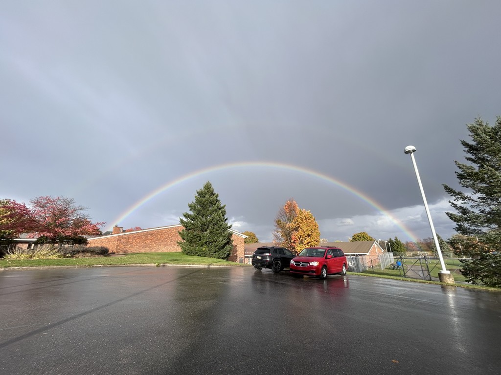 Image of large rainbow over the North Ed Arnell and Creekside School buildings.