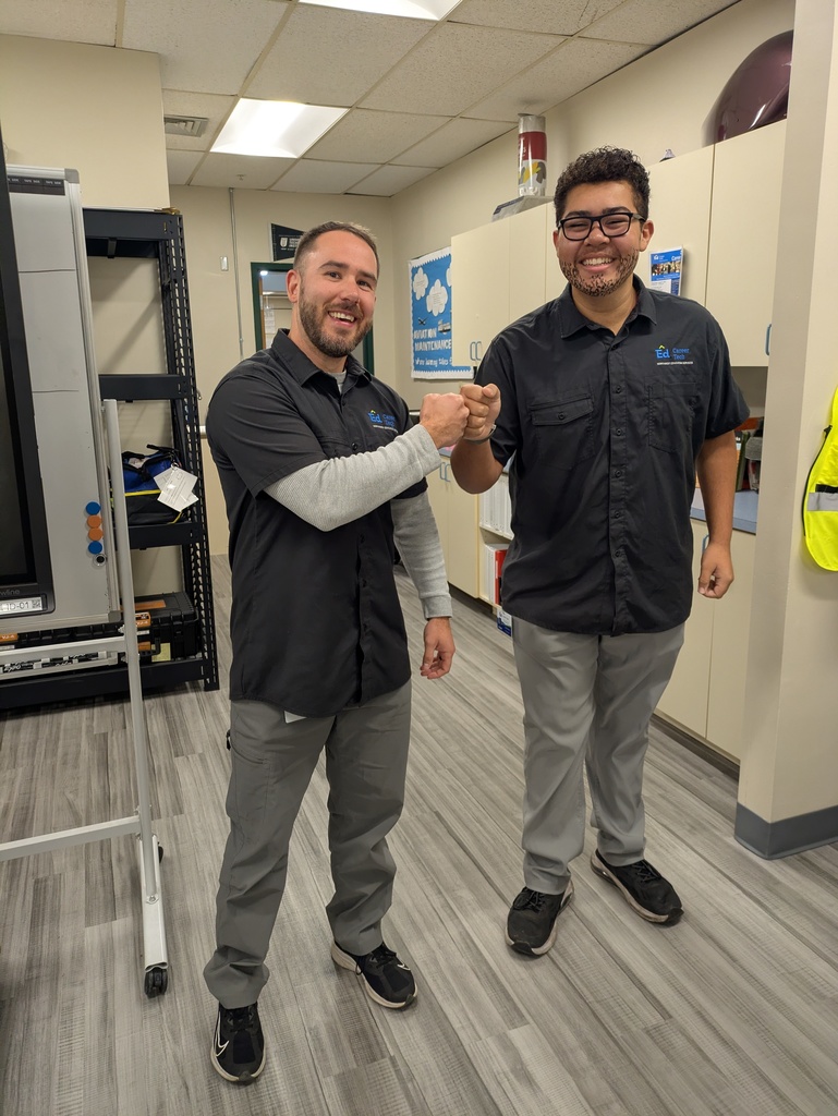 Image of Aviation Maintenance student Cash fist bumping instructor Mr. O'Dell on Dress Like Your Instructor day.