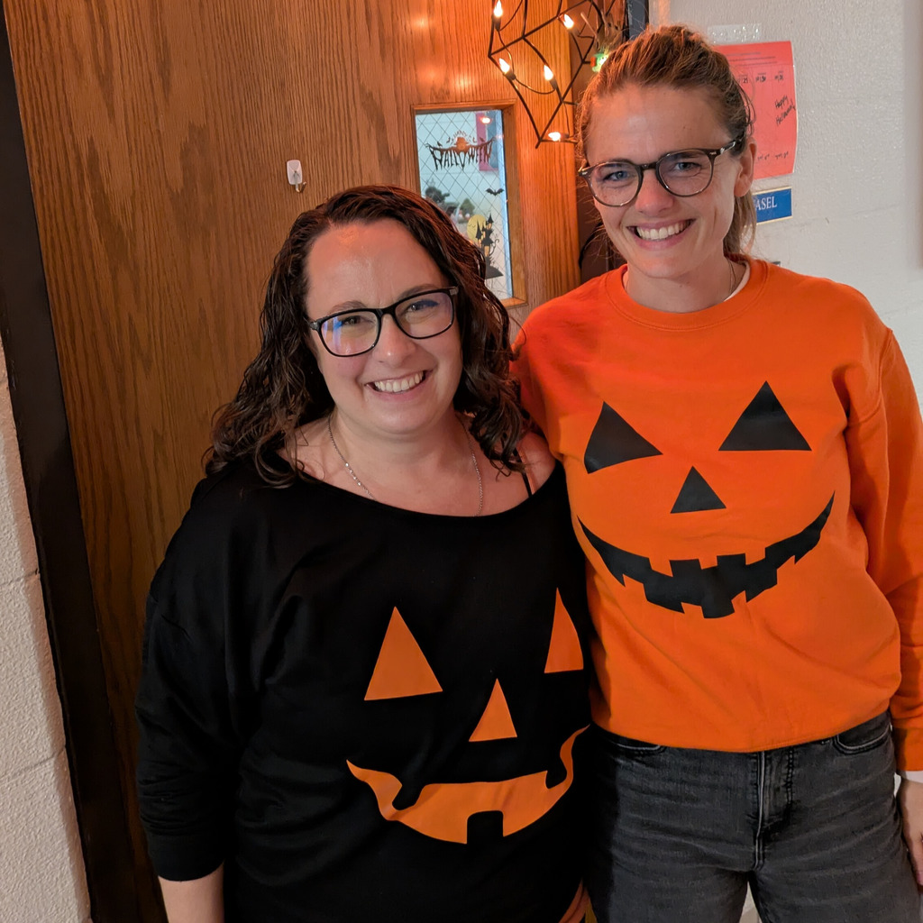 Two North Ed staff members wearing jack-o-lantern shirts.