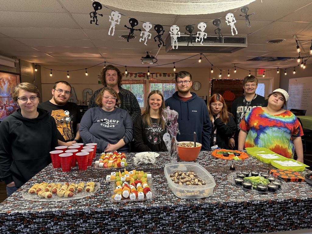 Group photo of ACE Downtown students with an assortment of Halloween themed treats,