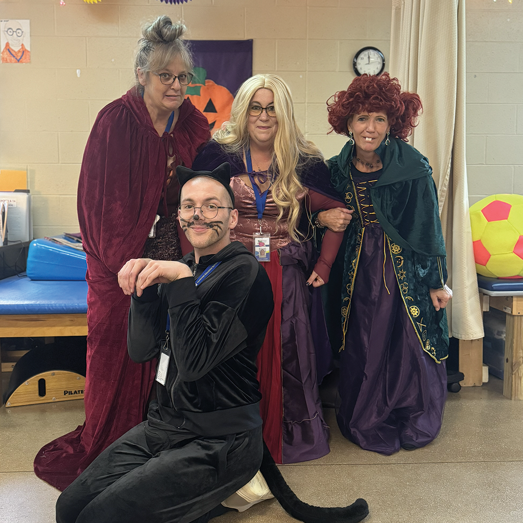 Transition Campus staff dressed as the Sanderson Sisters and cat Thackery Binx from  Hocus Pocus