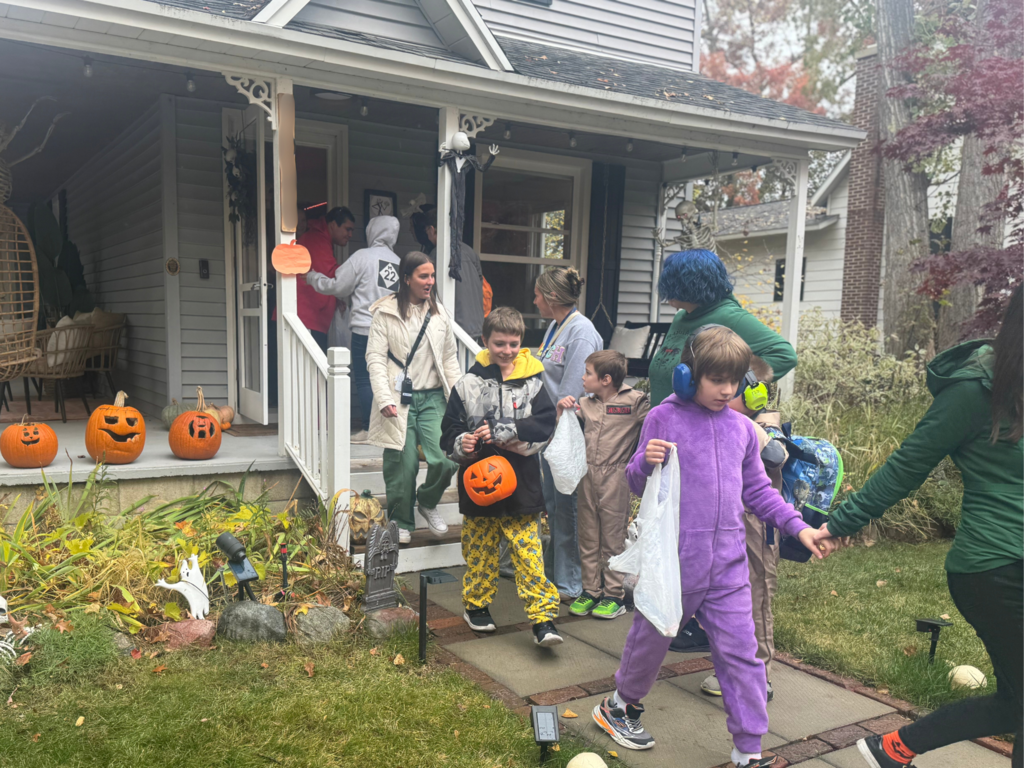 Group of North Ed Bridgeway students, staff and families trick or treating in their costumes.