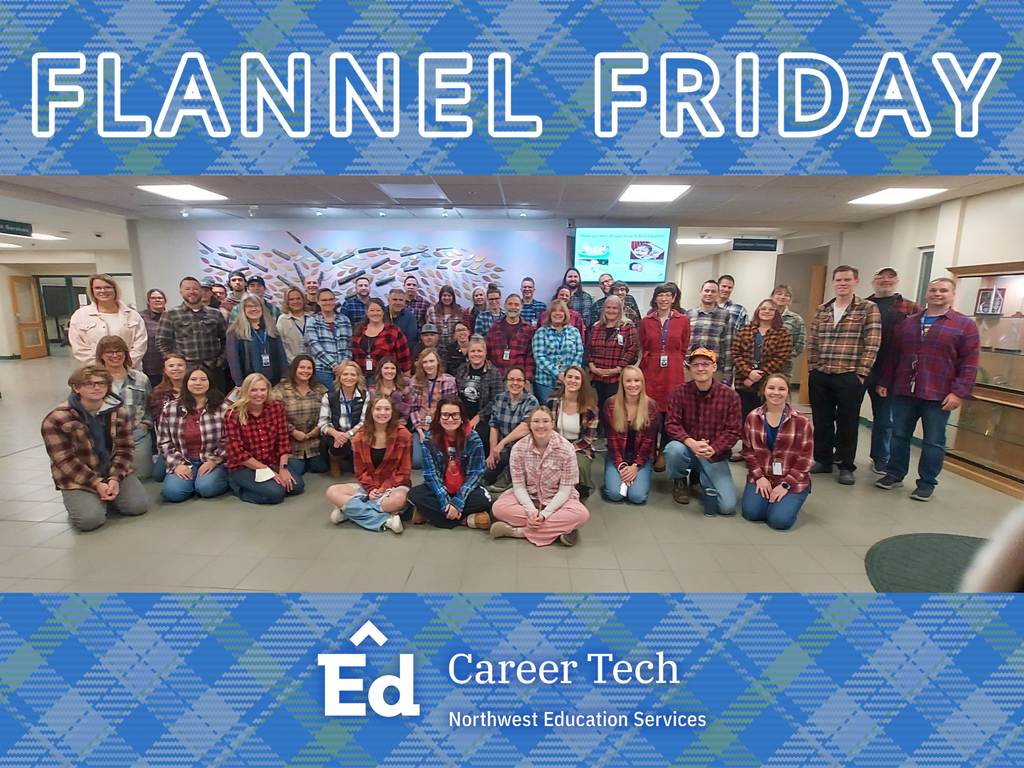 A large group of students and staff wearing flannel shirts gather inside a school lobby area. They are standing and kneeling in several rows in front of a colorful wall art installation. Above the group is a blue plaid banner with large white text that reads “FLANNEL FRIDAY.” A matching blue plaid footer contains the Northwest Education Services Career Tech logo.
