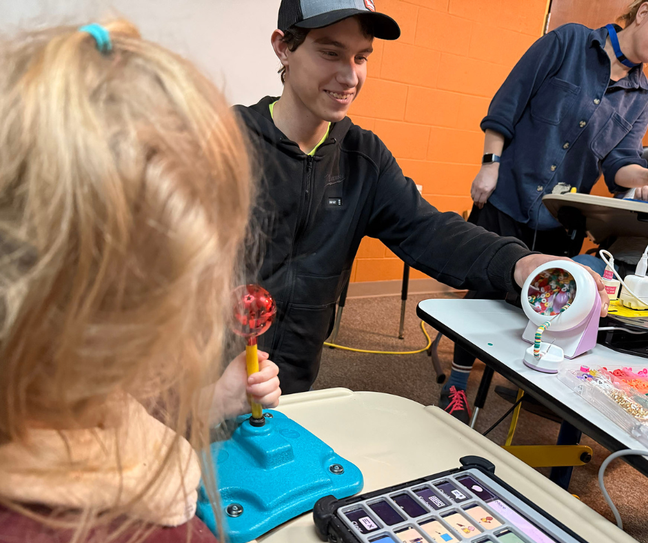 Career Tech and New Horizons students playing with adaptive toys. 
