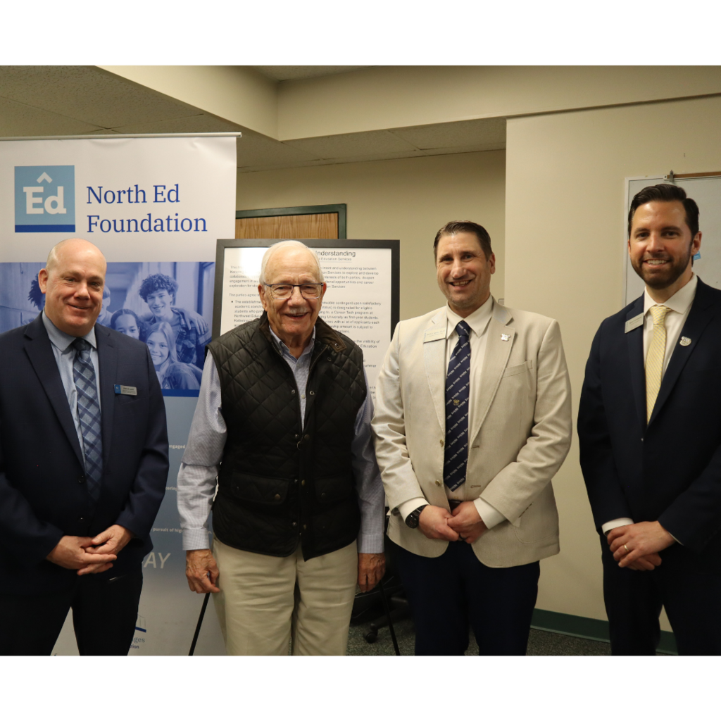 Pat Lamb, Al Jordan, Dr. Rob Kniss and Matt Fortescue posing in front of Memorandum of Understanding.