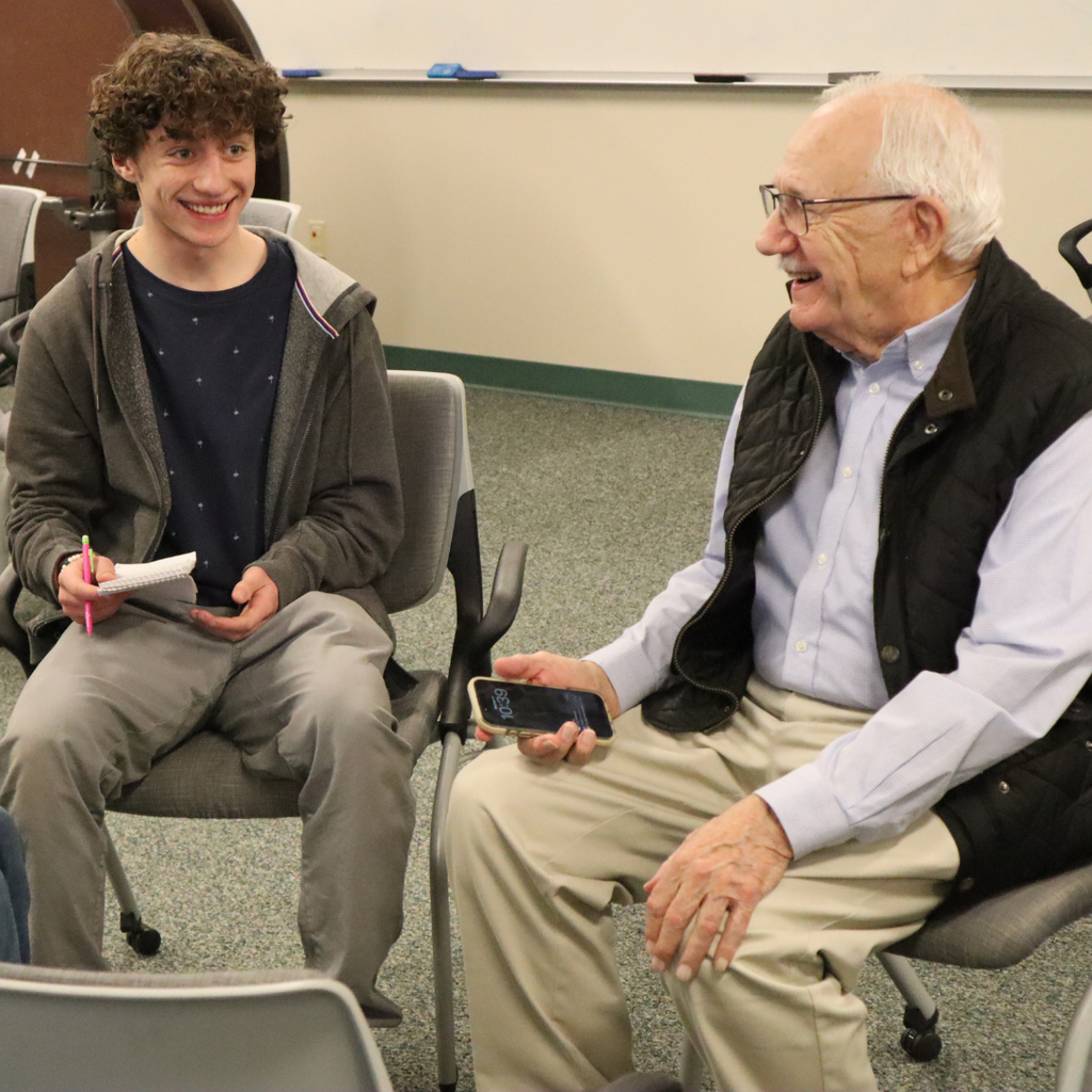 Writers Studio Student sitting and smiling with Al Jordan.