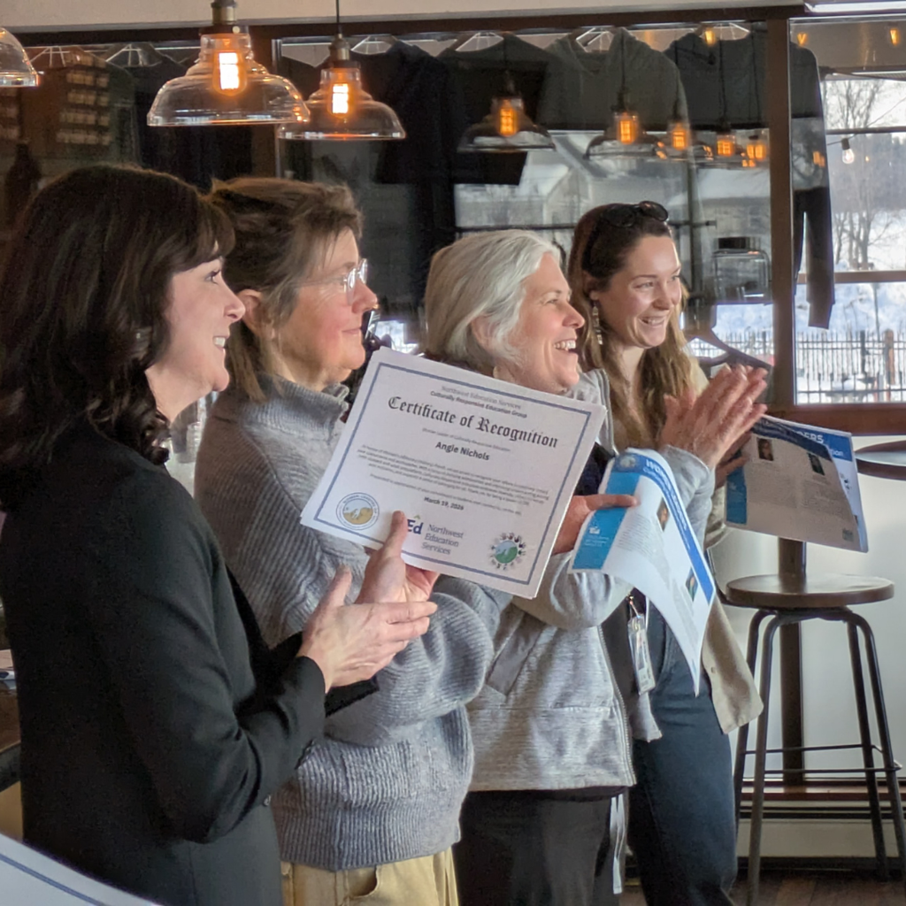 Attendees smiling as honorees collect their certificates