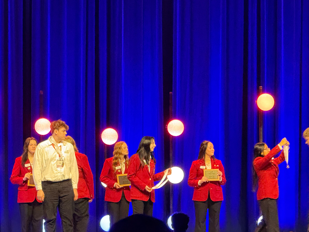 Electrical Occupations student Cohl Jennings on stage at 2026 SkillsUSA Michigan accepting the Bronze Medal for Industrial Motor Controls. 