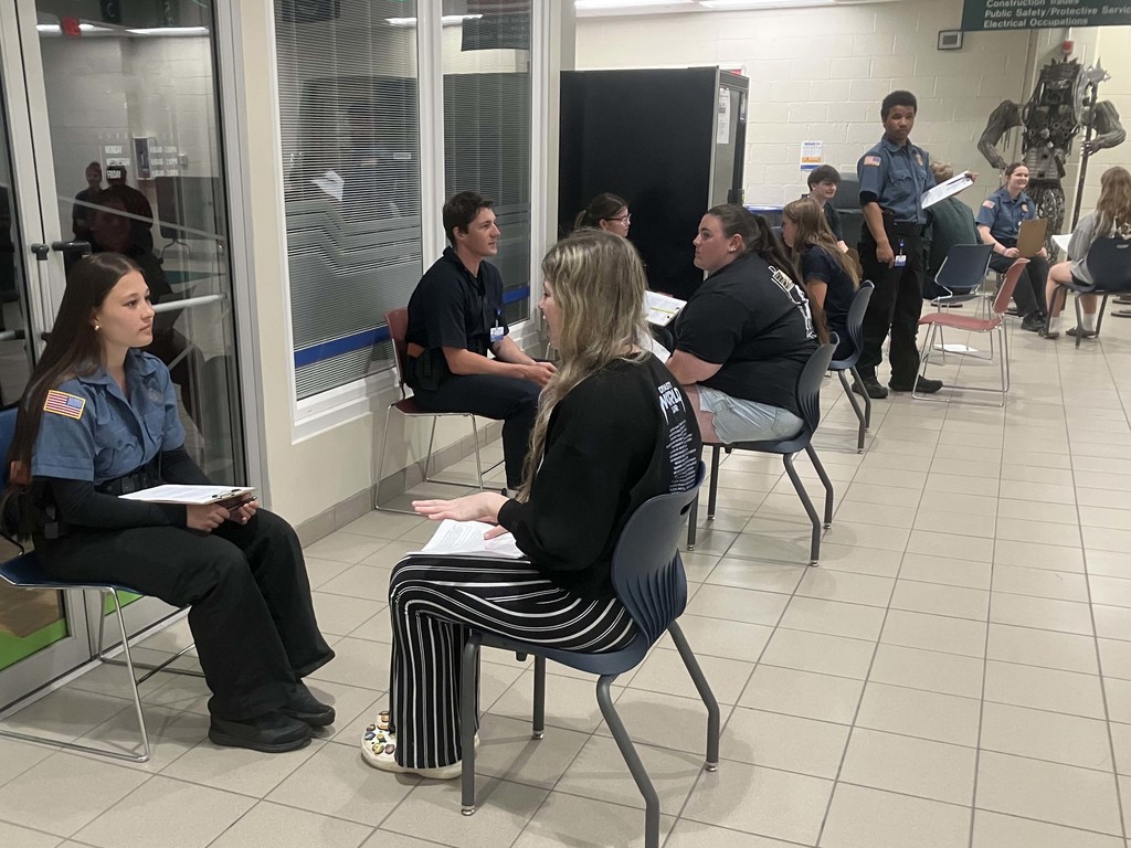 Business Careers and Public Safety students sitting in groups of two in a common area of North Ed Career Tech practicing their interview skills during “Speed Interviews”. 