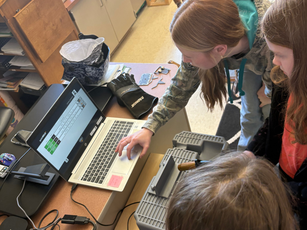 North Ed Career Tech welding student demonstrating a computer simulation for several 4th graders at Cherry Knoll Elementary. 