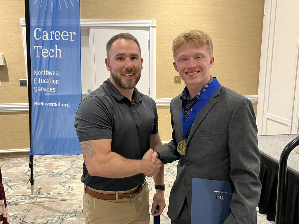 North Ed Career Tech instructor and student shaking hands and posing for a photo at North Ed Career Tech Awards Night. 