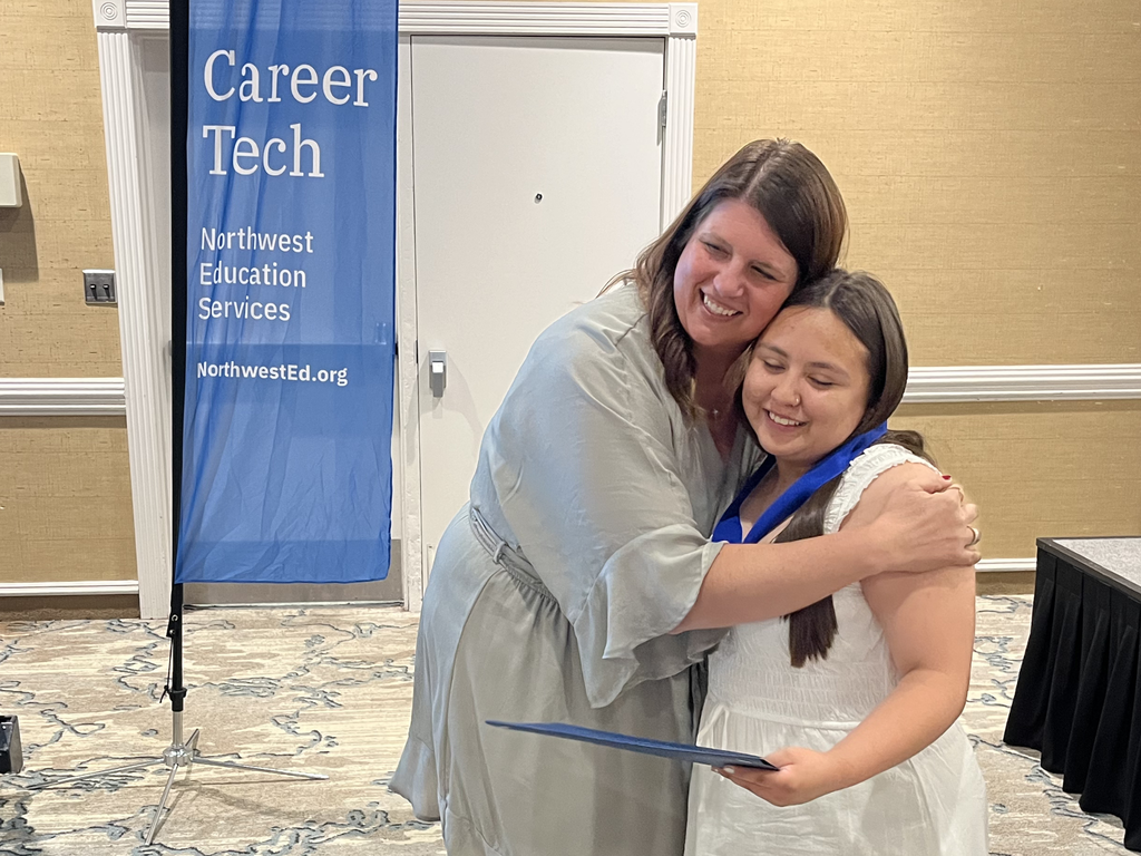 North Ed Career Tech instructor and student hugging after receiving award and medal at North Ed Career Tech Awards Night. 