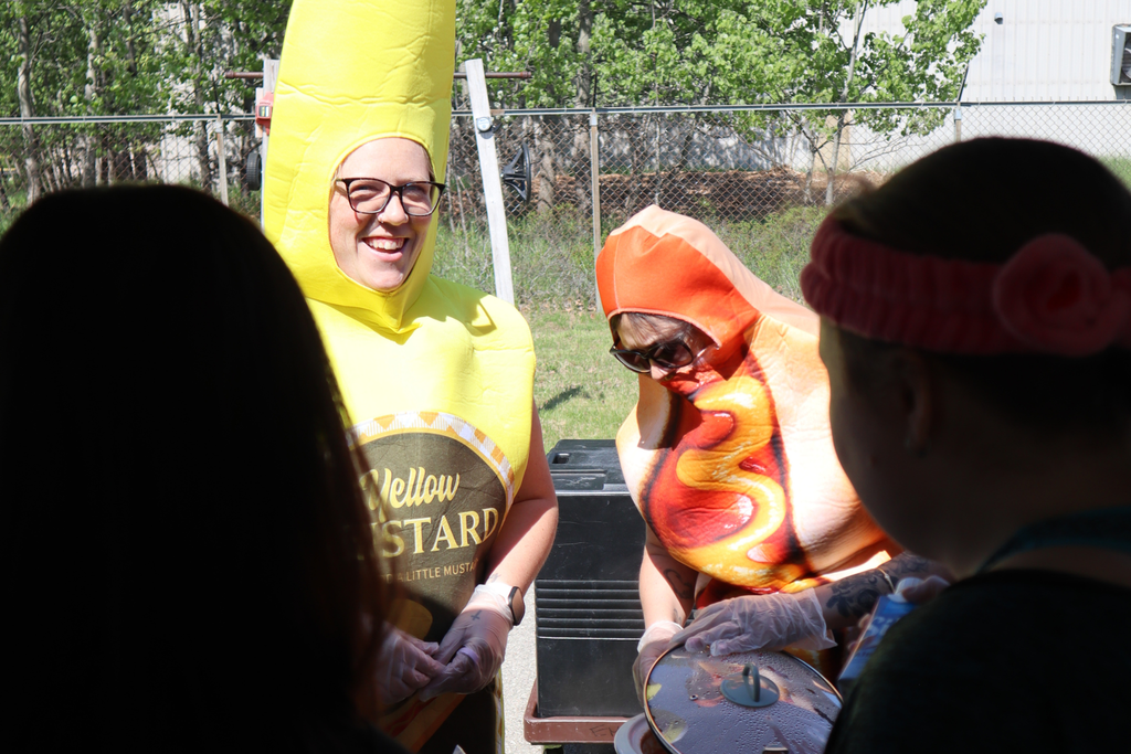 Transition Campus staff dressed as mustard and a hot dog at the annual picnic.