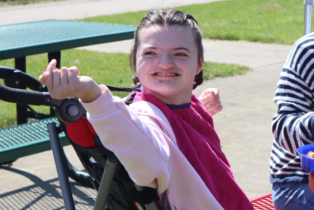 Transition Campus student smiling at a picnic table.