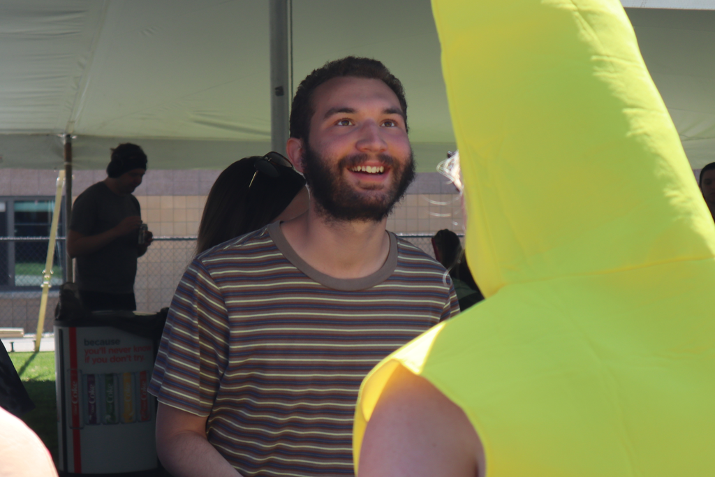 Transition Campus student smiling at staff member wearing mustard costume.