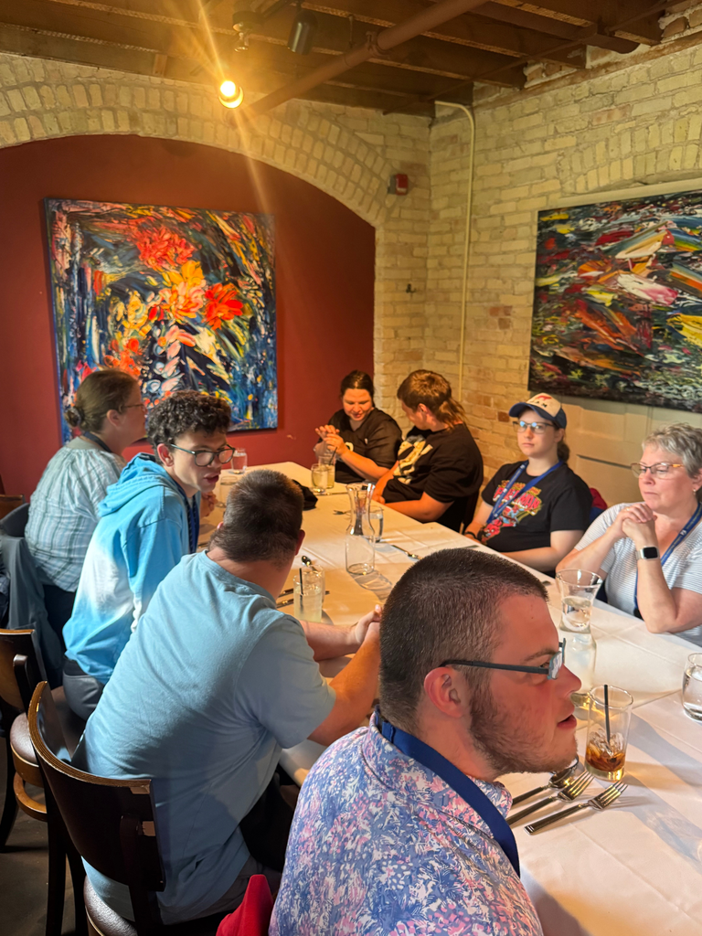 Candid photo of Transition Campus Work Experience Program students and staff having lunch at Trattoria Stella in celebration of the end of the work year.