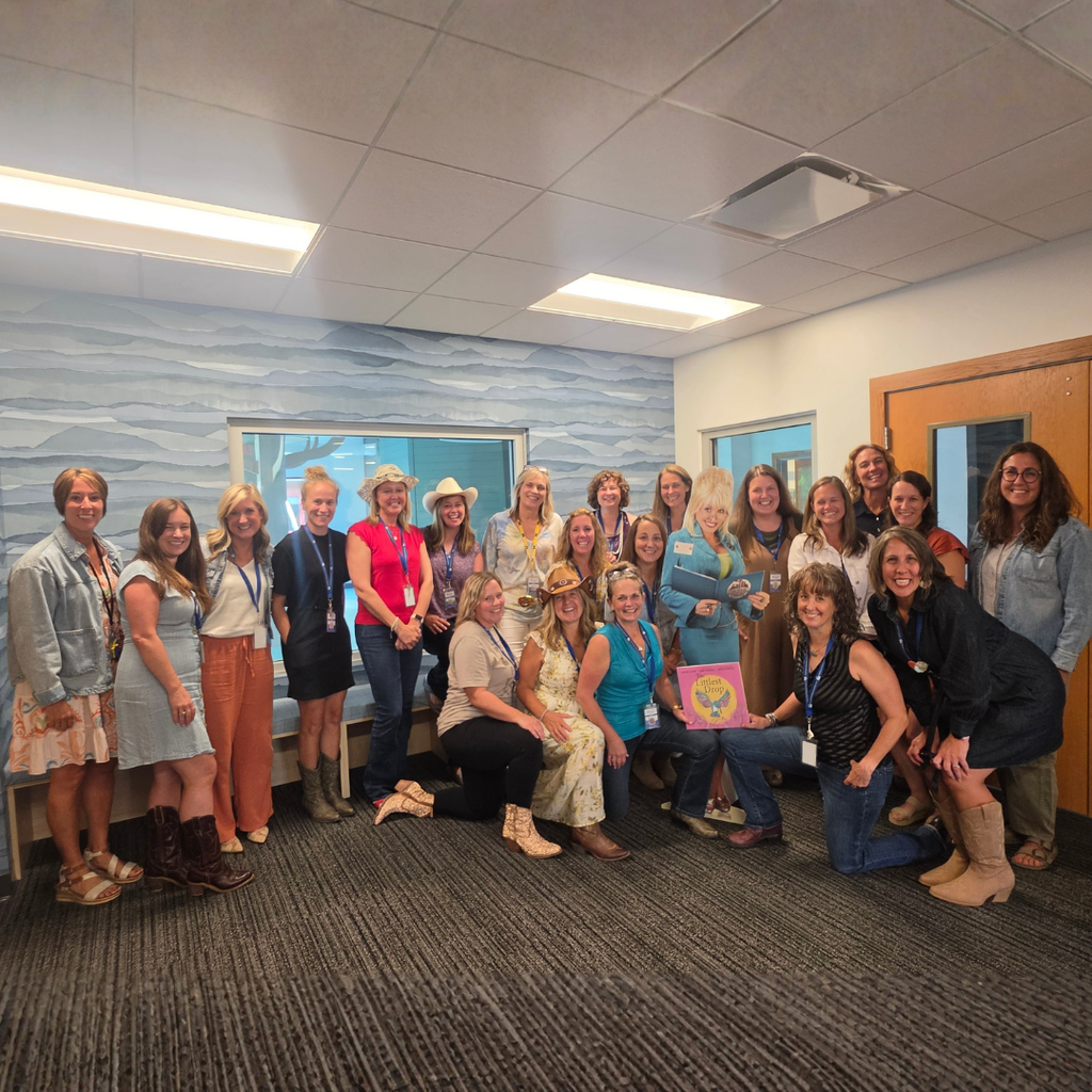 The North Ed Early Childhood team standing outside of the playgroup area of the Fisher Center, wearing sparkly western wear.