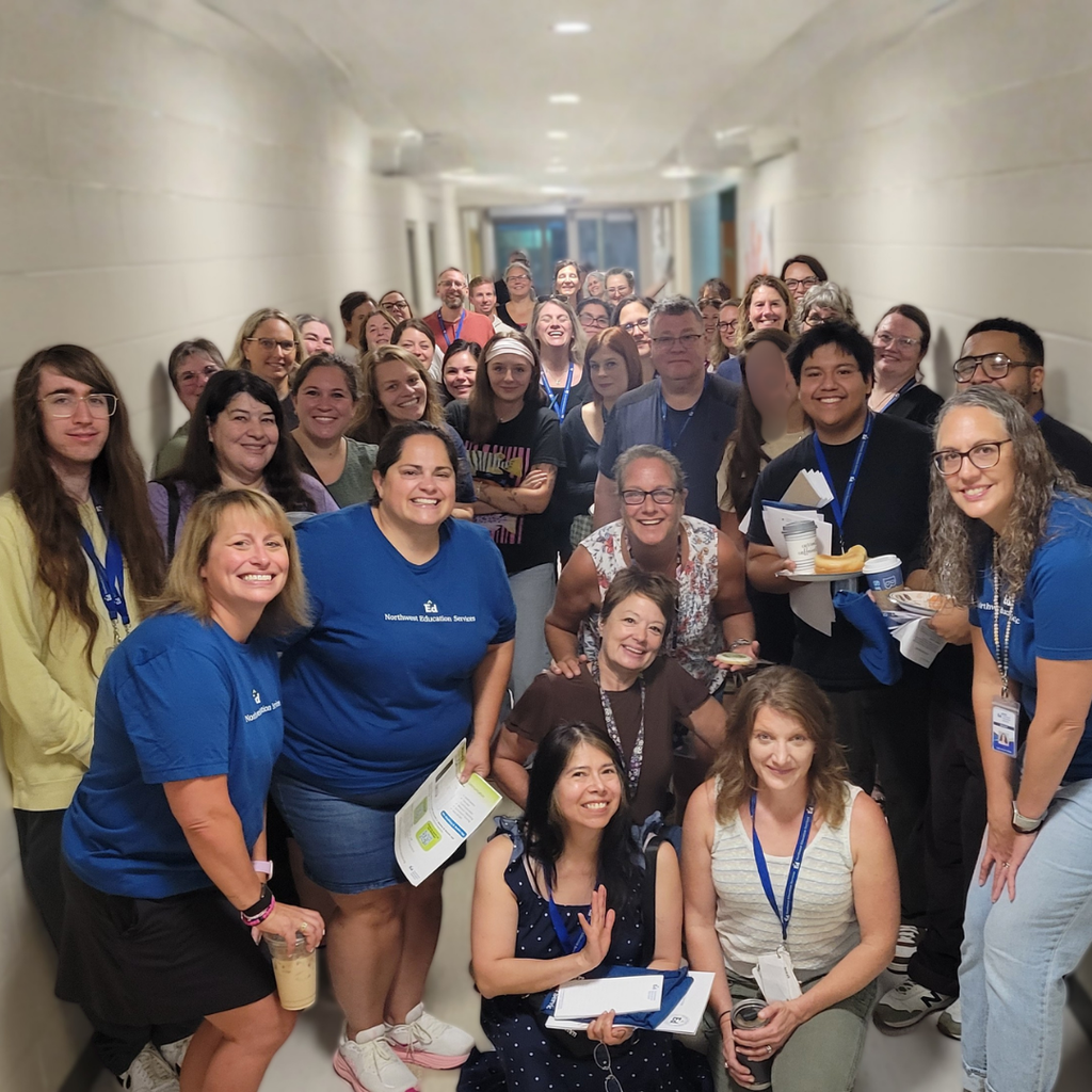 North Ed New Horizons staff posing for a group photo in the hallway on Opening Day. 