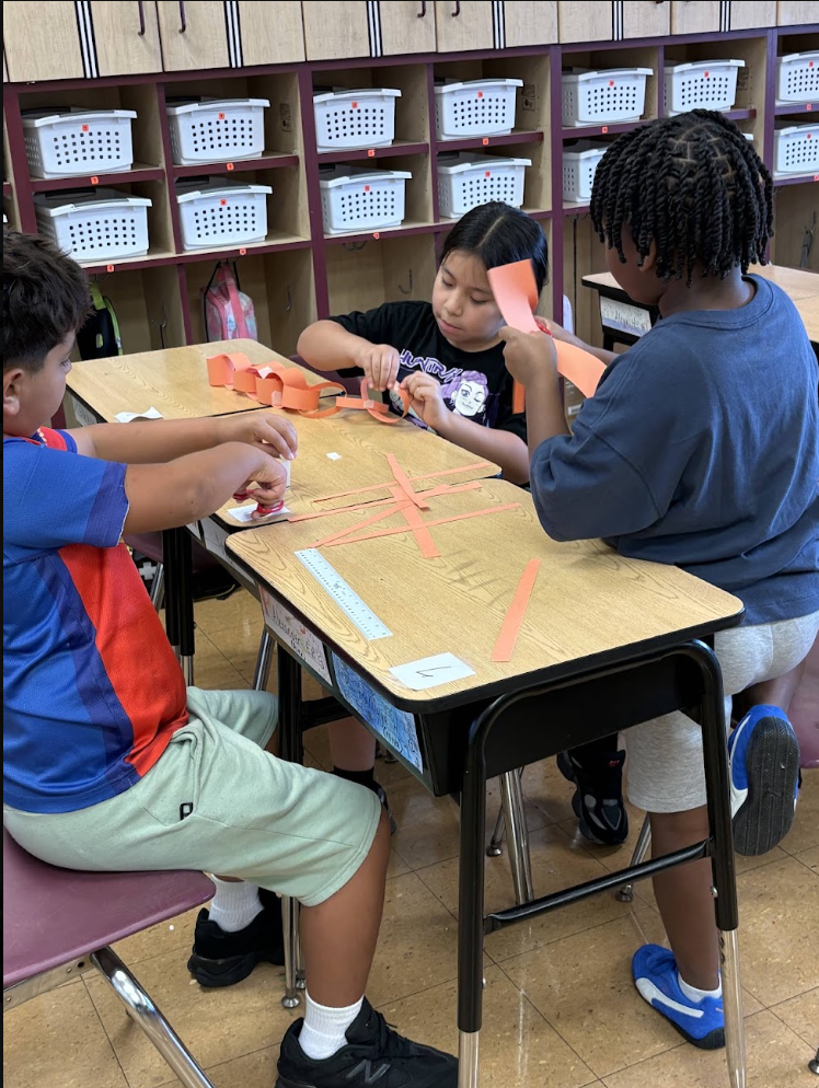 students cutting strips of paper