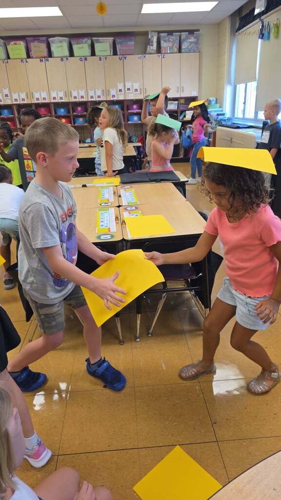 students with paper on their heads