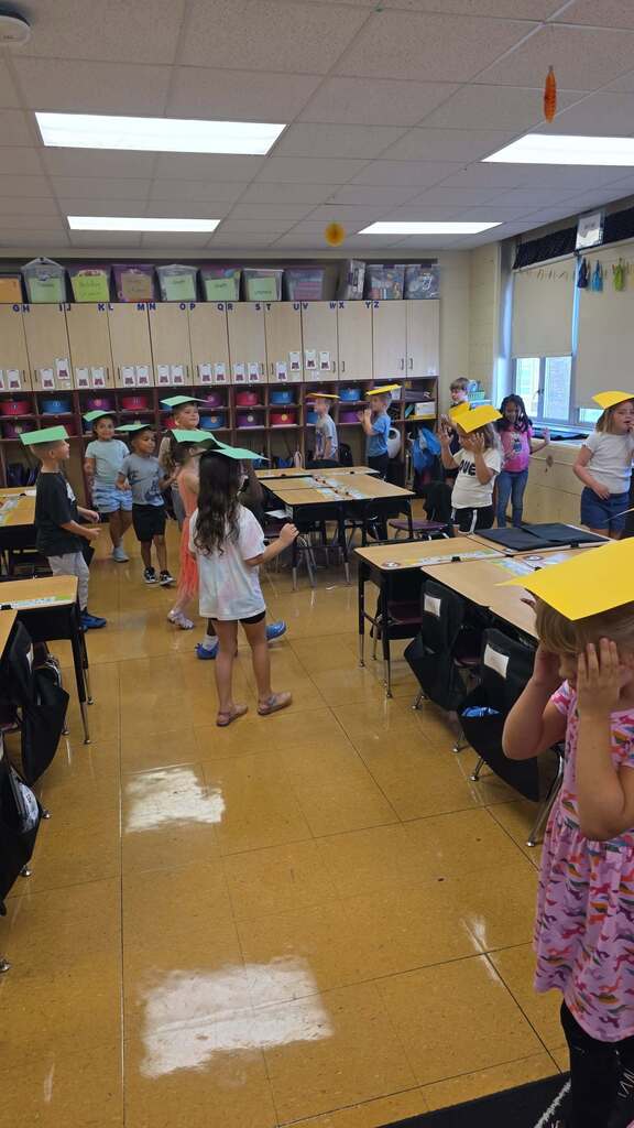 students with paper on their heads