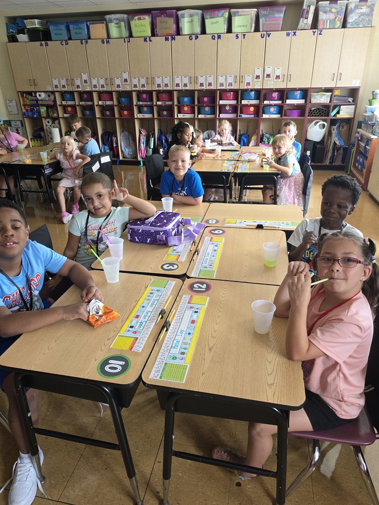 students at desks drinking juice
