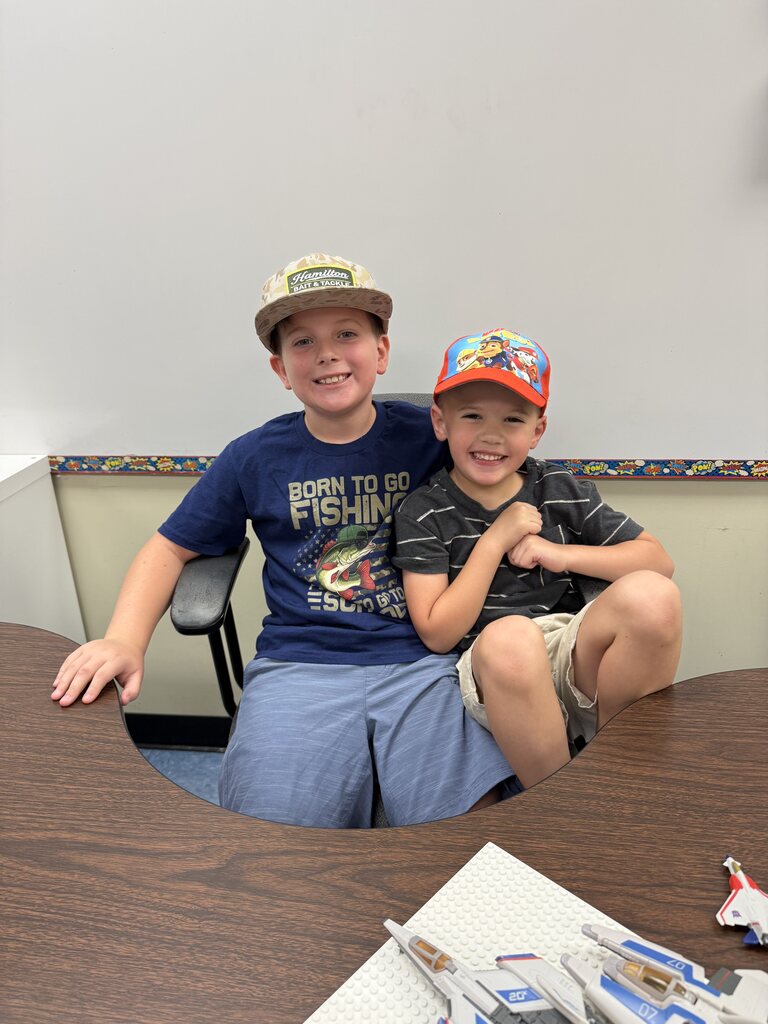 two students wearing hats