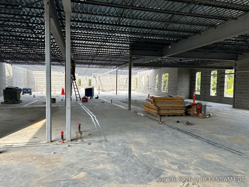 Crews are pouring the concrete floor for the top-floor classroom wing, and the walls for the lower level are starting to go up.
