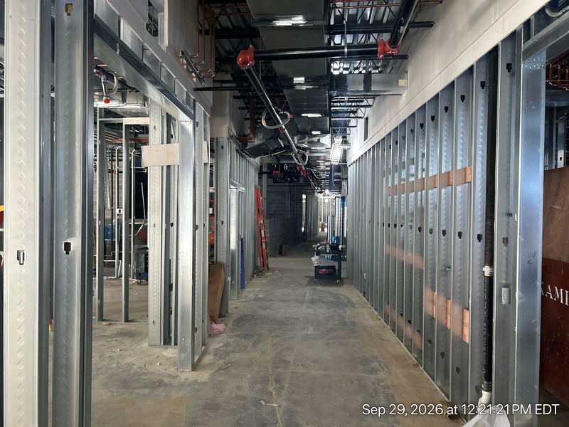 Crews continue installing the building's "nervous system" (wiring, plumbing, and heating) on the lower level, while walls are framed on the main level.