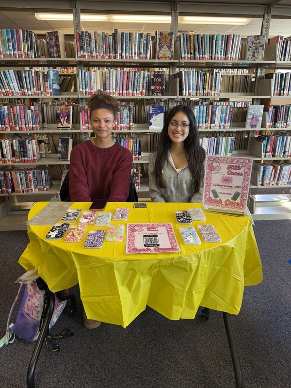 two girls sitting at a table