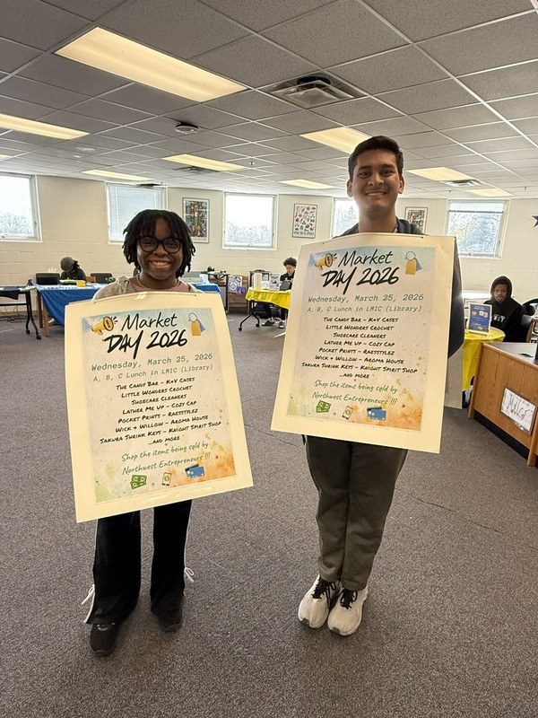 two students holding signs